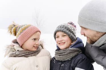 Father with children enjoying vacation during winter - EYAF01469