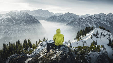 Germany, Bavaria, Ammergau Alps, Teufelstattkopf, Tourist hiking in mountains at winter day - RBF08071