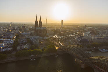 Germany, Cologne, Rhine River, View of river and city at sunset - TAMF02800