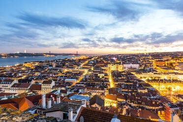 Portugal, Lisbon, View of city with Ponte 25 de Abril on Tagus river in distance at dusk - EGBF00639