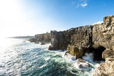 Sea waves crashing against cliffs with cave - EGBF00646