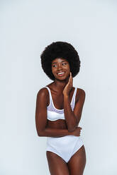 Afro-American skinny woman wearing lingerie pointing while