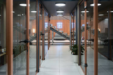 Interior of corridor by glass doors at workplace - VPIF03512