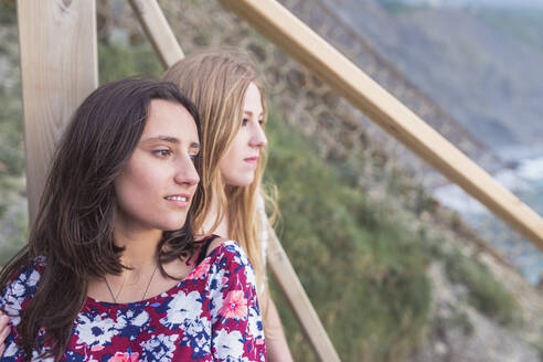Beautiful female friends looking at view from observation point - SNF01039