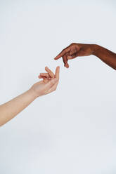 Women gesturing toward each other against white background - OIPF00172