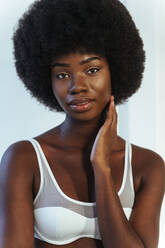 Afro-American skinny woman wearing lingerie with arms crossed