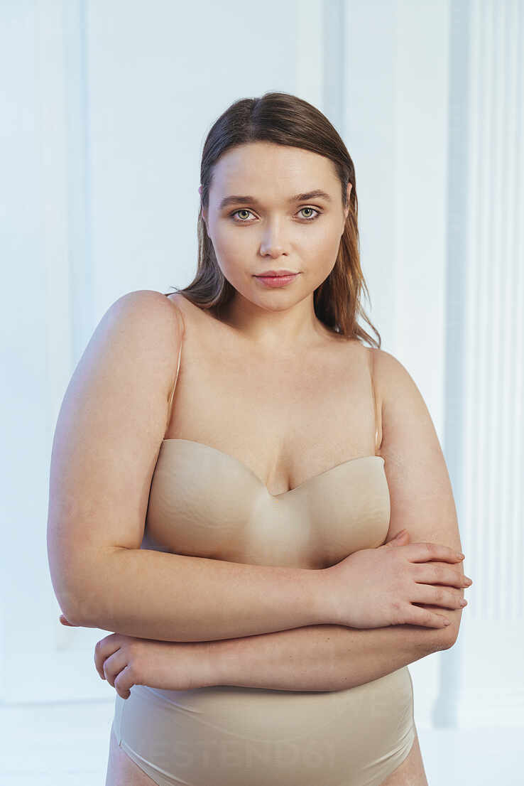 beautiful chubby girl in lingerie and shirt standing Stock Photo
