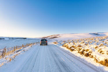 UK, Scotland, East Lothian, Winter sunrise over road through rural landscape - SMAF01984