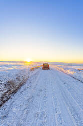 UK, Scotland, East Lothian, Winter sunrise over road through rural landscape - SMAF01985