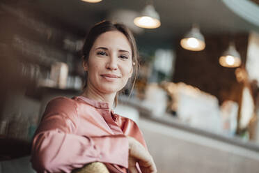 Smiling female professional at cafe - JOSEF03221