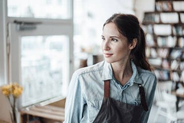 Beautiful female owner contemplating at cafe - JOSEF03237