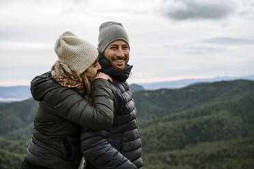 Smiling tourist couple standing at viewpoint - AFVF08127