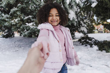 Niedliches Mädchen hält Hand der Mutter im Park im Winter - EBBF02305