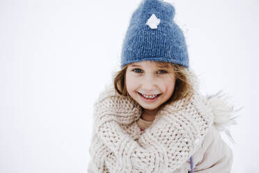 Cute smiling girl in knitted warm clothing during winter - KMKF01511