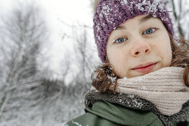 Teenage girl in warm clothing at snow during vacations - OGF00830