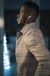 African man listening music while looking away - MPPF01466