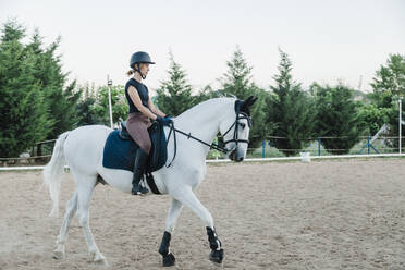 Female doing horseback riding in farm - MRRF00851