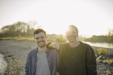 Happy father and son against clear sky at evening - GUSF05274