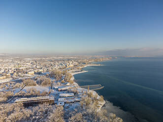 Germany, Baden-Wurttemberg, Radolfzell, Aerial view of snow-covered town on shore of Lake Constance - ELF02354