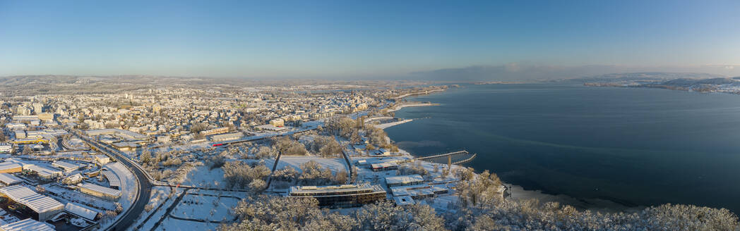 Germany, Baden-Wurttemberg, Radolfzell, Aerial view of snow-covered town on shore of Lake Constance - ELF02355