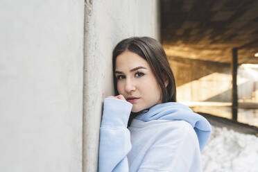 Young woman staring while leaning on wall - JCCMF01048