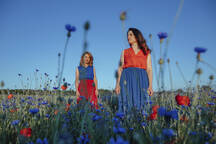 Premium Photo  A girl in a blue bra and a blue bra stands in a field of  flowers.
