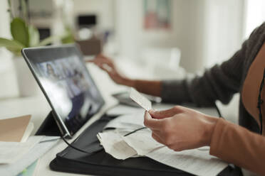 Close up woman with credit card paying bills at digital tablet - CAIF30286