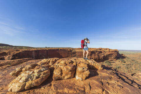 Female hiker photographing landscape of Kings Canyon stock photo
