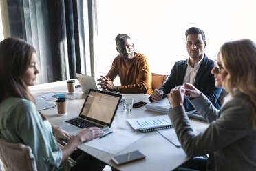 Team having discussion while sitting in meeting at office - JSRF01332