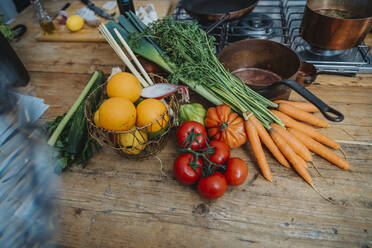 Fruits and vegetables by kitchen utensil on kitchen island - MFF06982