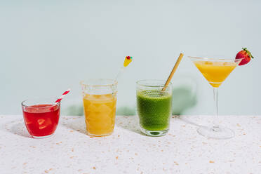 Healthy summer cocktails on terrazzo marble against wall at home - GEMF04623