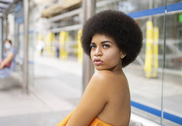 Young woman looking away at footpath - JCCMF01147