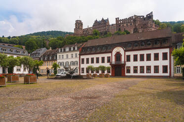 Germany, Baden-Wurttemberg, Heidelberg, Facade of Heidelberg Academy of Sciences and Humanities with Heidelberg Castle in background - TAMF02876