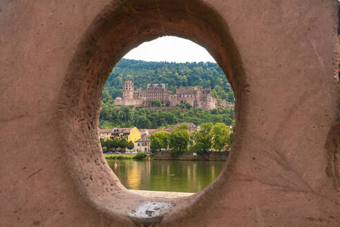 Germany, Baden-Wurttemberg, Heidelberg, Heidelberg Castle seen through circular hole of Liebesstein sandstone - TAMF02889