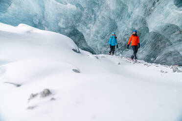 Friends Exploring Frozen Ice Caves In Alberta - CAVF92191