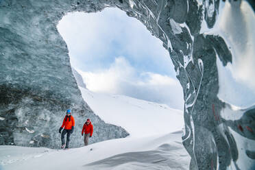 Couple Exploring The Inside Of Glaciers On The Icefields Parkway - CAVF92195