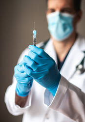 Close up of doctor holding needle with vaccine ready to inject. - CAVF92222