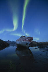 Northern Lights - Aurora Borealis in sky over boat wreckage, Tasiilaq, Greenland - CAVF92312