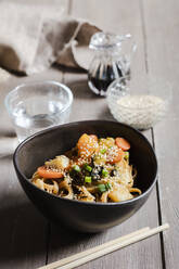 Bowl of vegan pasta with vegetables and sesame seeds - EVGF03901