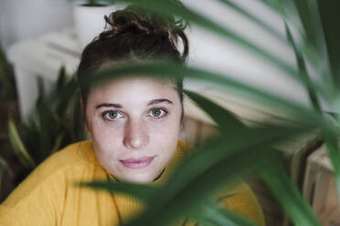 Woman staring while sitting at home - EBBF02412