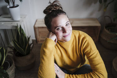 Woman smiling while sitting at home - EBBF02459