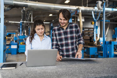 Young expertise using laptop while working at industry - DIGF14398