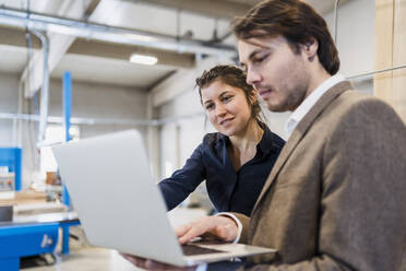 Business people using laptop while working at industry - DIGF14453