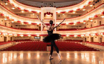 Anonymous ballerina finishing performance in empty theater - CAVF92430