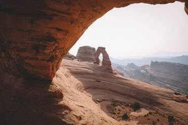 Delicate Arch Seen in the Distance from Another Archway - CAVF92533