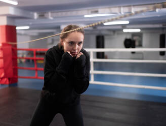 Female boxer in full crouch stance - CAVF92675