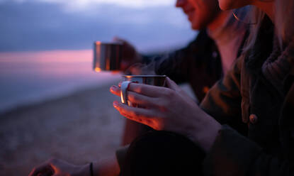 Crop couple enjoying tea at night - CAVF92709