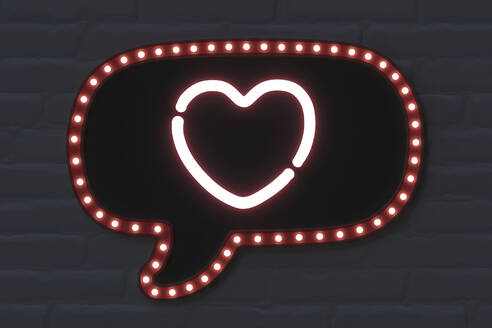 Illuminated speech bubble with heart shape on black brick wall - NMCF00002