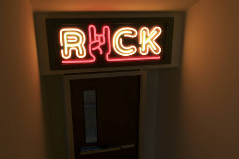 Illuminated rock text with horn sign on door - NMCF00023