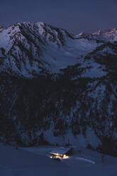 Illuminated cottage at snowcapped mountain during sunrise - JAQF00258